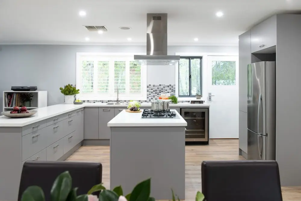 Large u shaped kitchen with grey cabinetry and standalone island bench