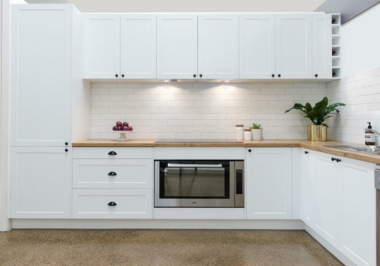 white ktichen with subway tiles and durapal benchtop
