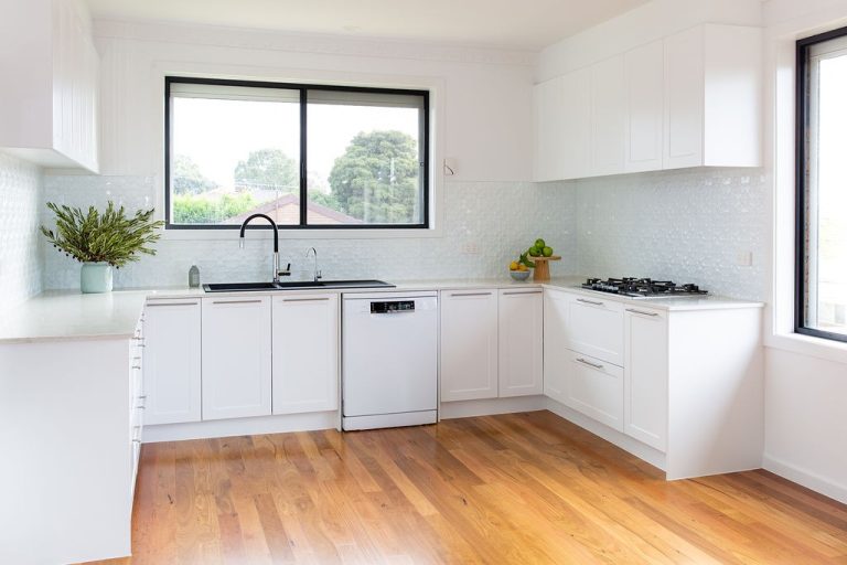white kitchen with wooden floors