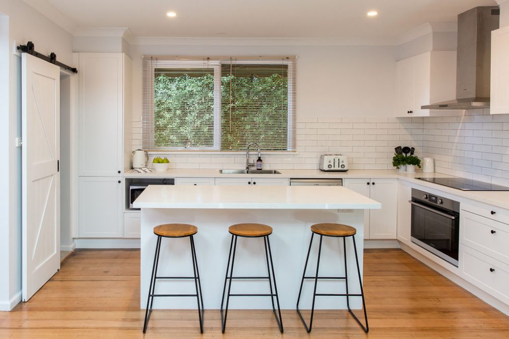 DIY Kitchen Renovation using white kitchen cabinetry and standalone stone island bench