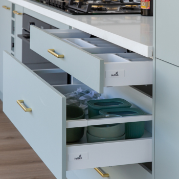 Drawer runners by Hettich displayed in green slide out drawers