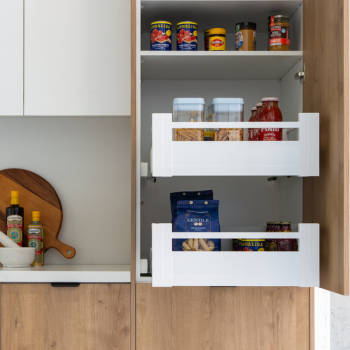 A shelf and two pull out drawers holding past and stales in a timber kitchen