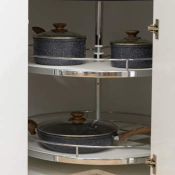 Lazy susan in corner kitchen cabinet displaying grey saucepan and pots