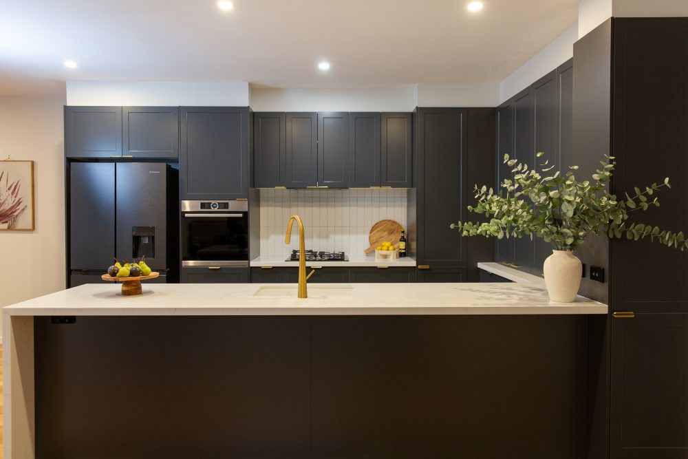 Shaker style u shaped kitchen using Terril dark cabinetry with white benchtops