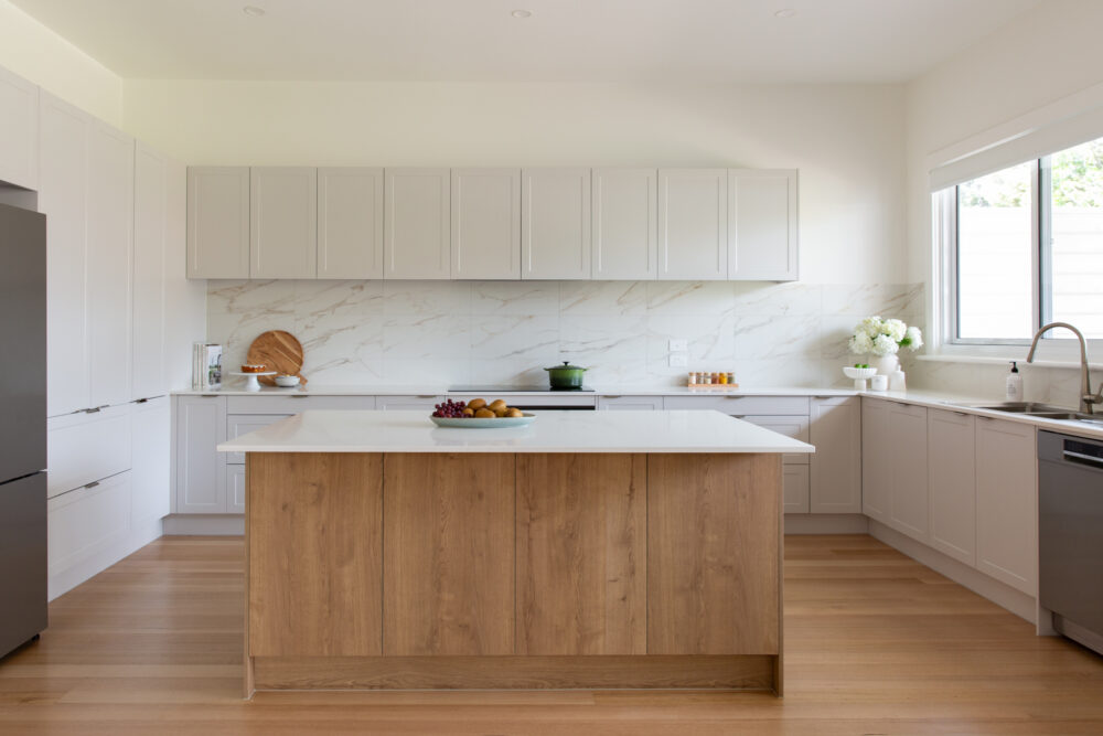 Large Light grey and timber kitchen cabinetry with white stone benchtops and large standalone island bench