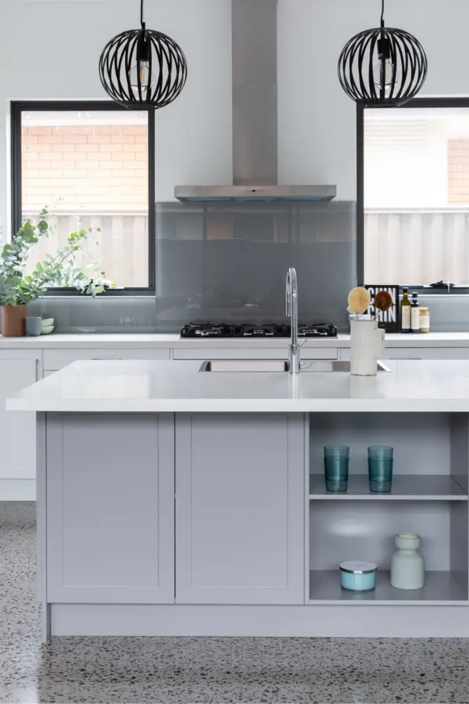 Grey and white kitchen cabinetry by Kitchen Shack with black lighting and kitchen accessories