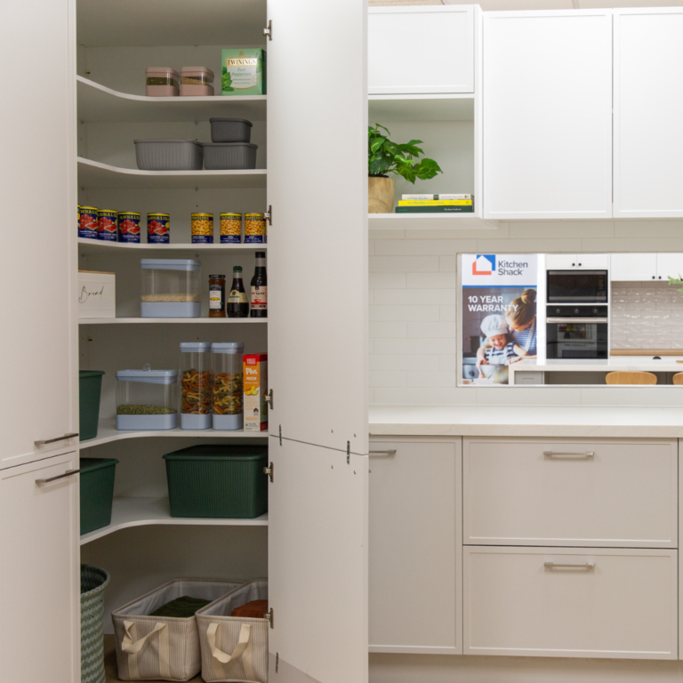 Corner pantry in parchment colour kitchen doors in kitchen showroom featuring pantry staples