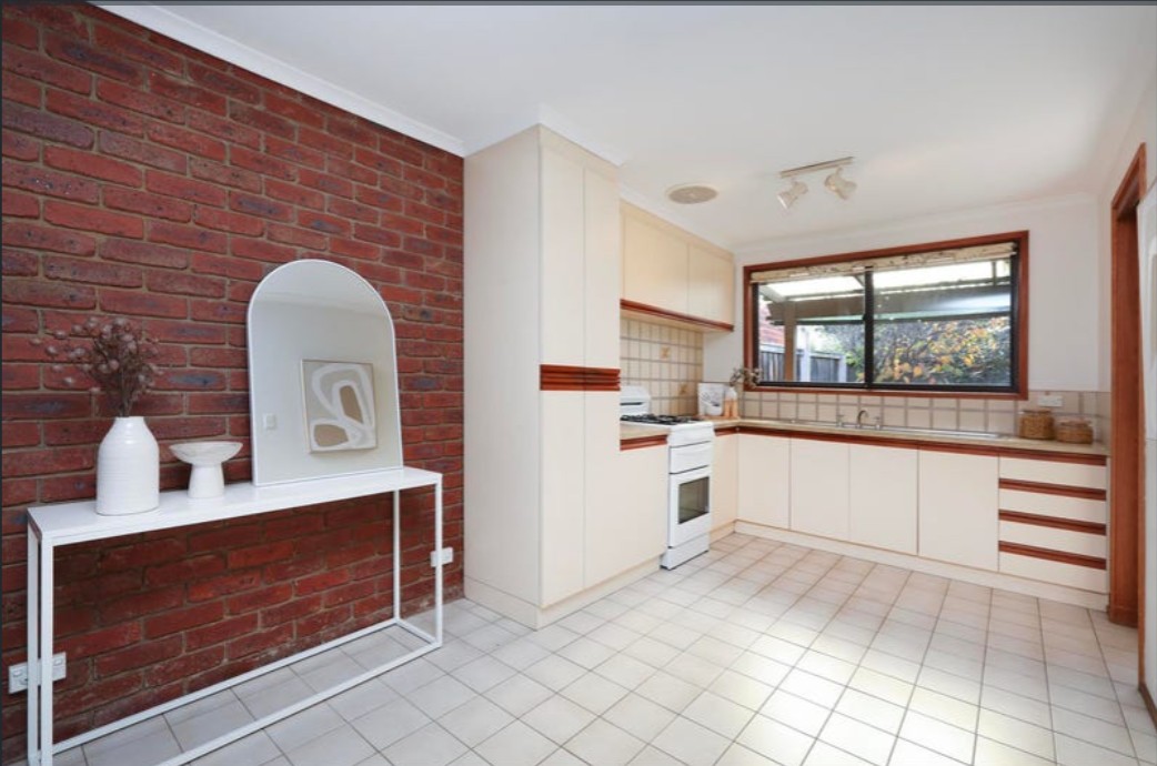 Old kitchen style with cream cabinetry and timber trim handles