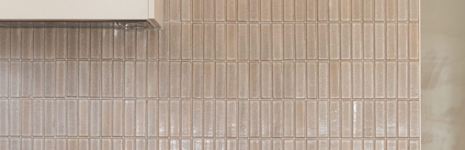 Kitchen benchtop displaying stone and chopping board, timber salt and pepper and plan on benchtop