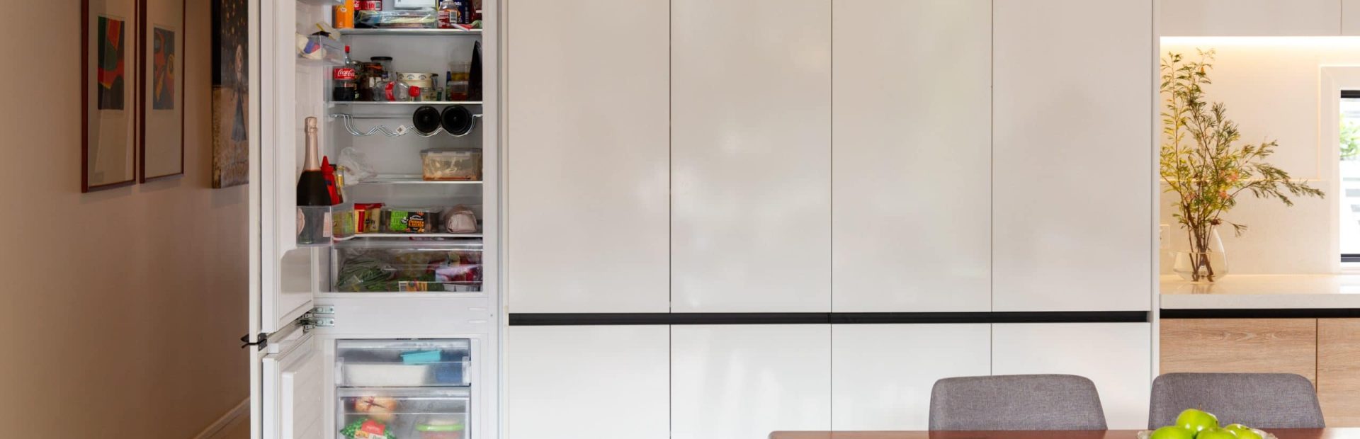 White cabinetry with integrated fridge