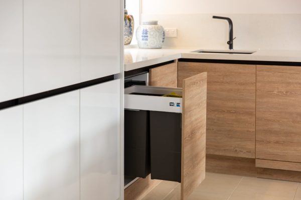 Timber laminate kitchen cabinetry displaying pull out extra large bins in a u shaped kitchen