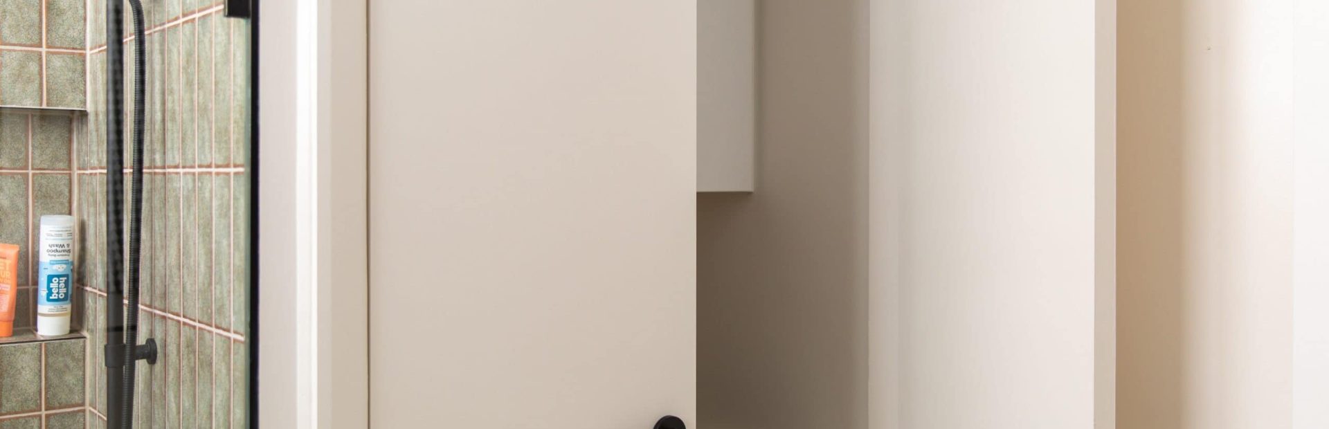 Laundry with sink hidden behind white doors