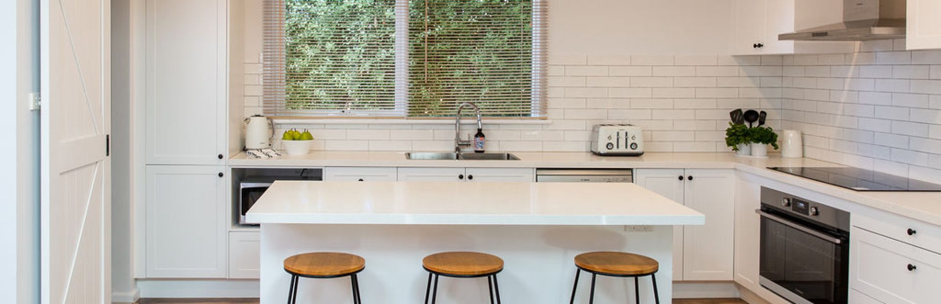 DIY Kitchen Renovation using white kitchen cabinetry and standalone stone island bench