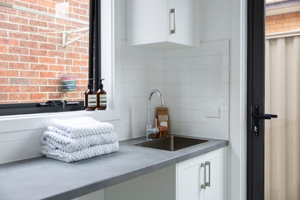 Laundry cabinetry with laminate Loftec grey benchtops