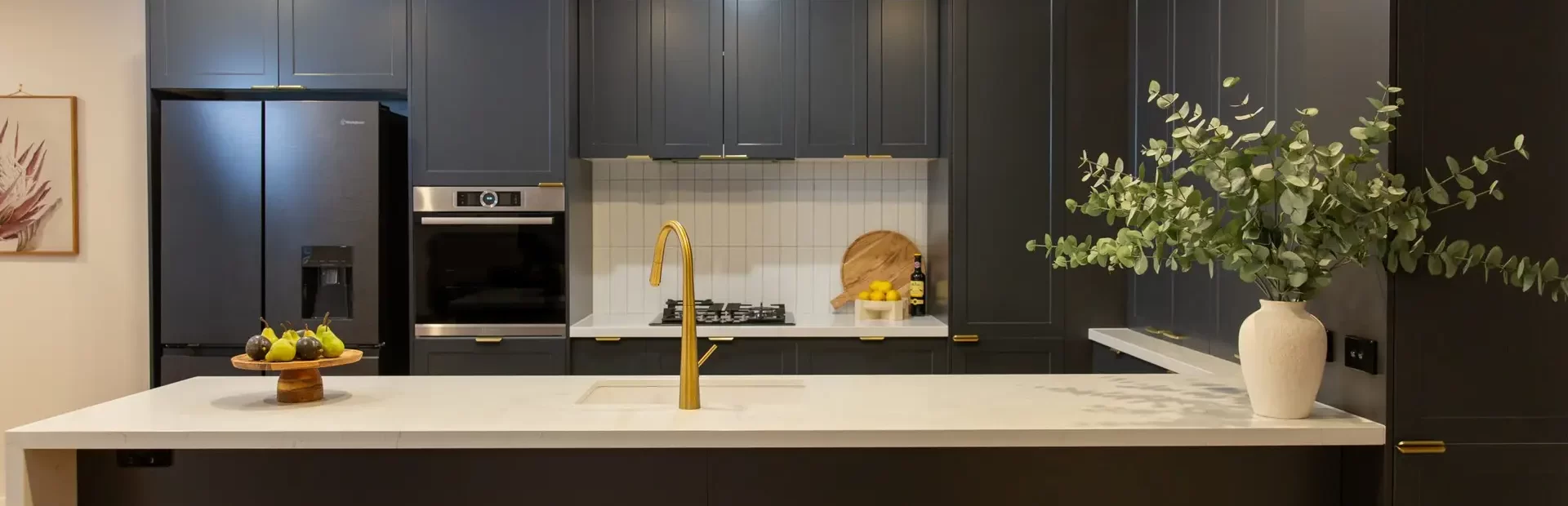 Shaker style u shaped kitchen using Terril dark cabinetry with white benchtops