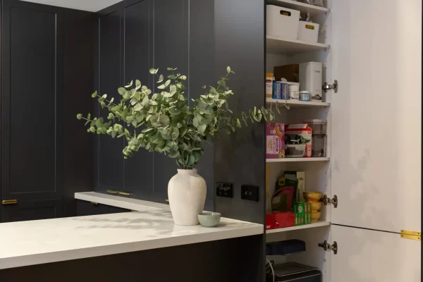Clever design of pantry at the end of u shaped shaker style kitchen for extra storage