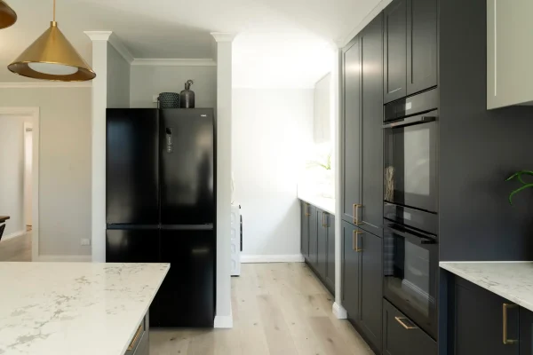Galley kitchen and laundry in shaker style in terril and oyster colour cabinetry as featured on Selling Houses Australia in North Fitzroy