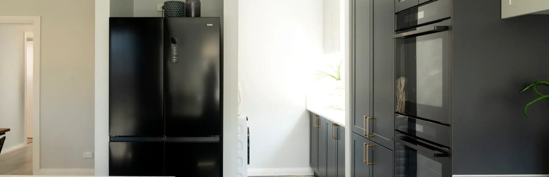 Galley kitchen and laundry in shaker style in terril and oyster colour cabinetry as featured on Selling Houses Australia in North Fitzroy